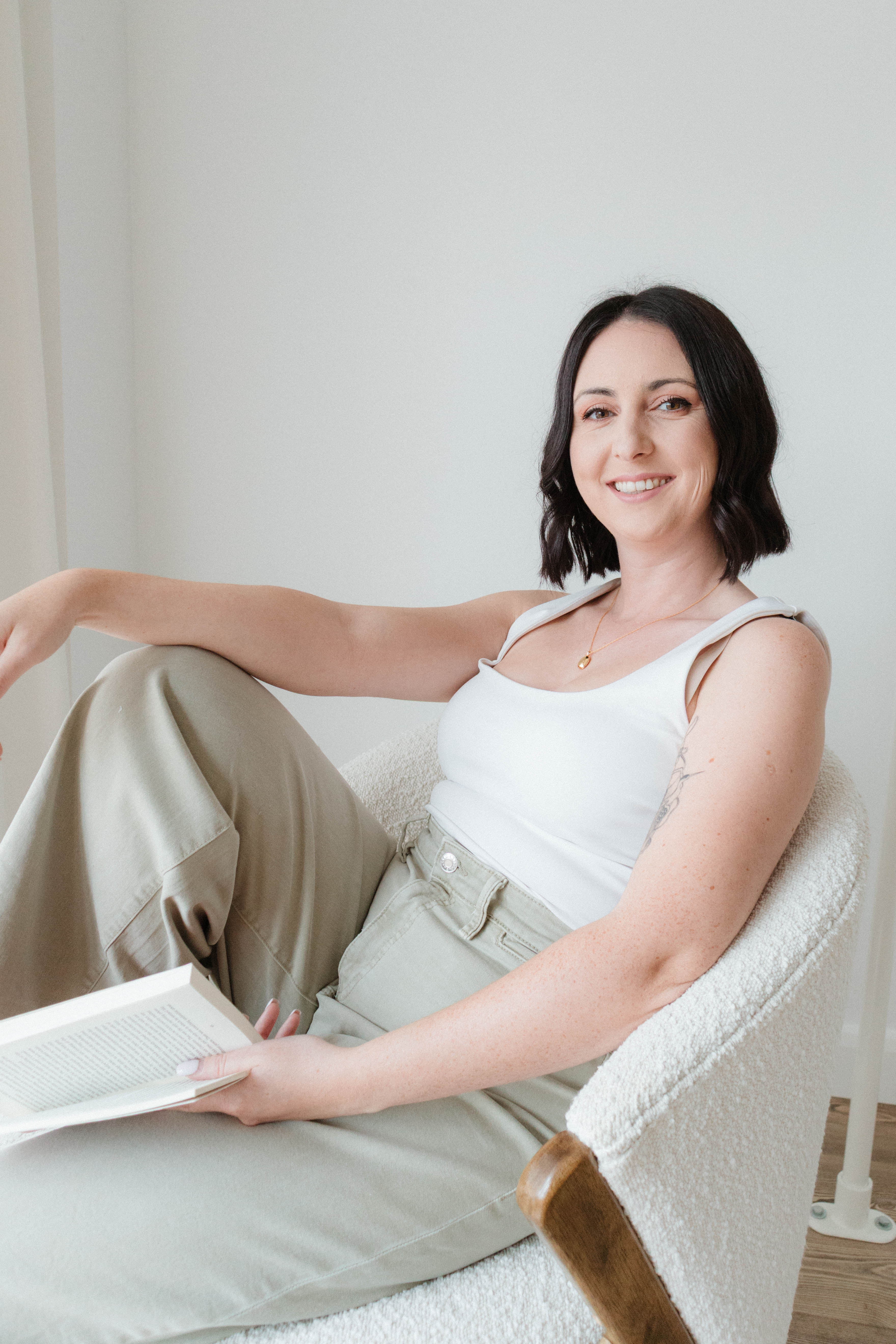 Lauren Cooper reading in a chair